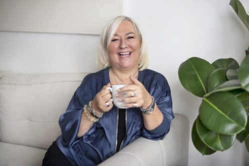 Frances Bentley Coach Bentley Author Motivational Speaker and mentor Blue Jacket and holding cup of coffee - Copy