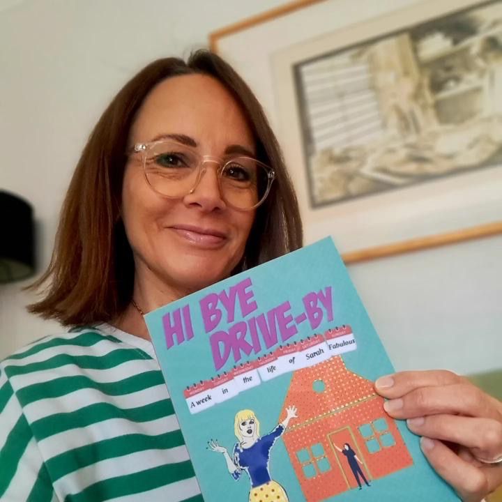 Maxine Aston Author Headshot with book Hi Bye Drive By